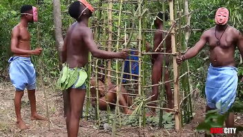 In a far away West African country, during the annual festival, the king has intercourse with the most beautiful woman locked in a cage while his queen and the guards watch.