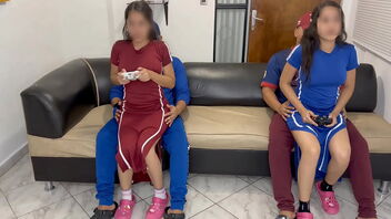 Latina cuties playing video games while sitting on legs